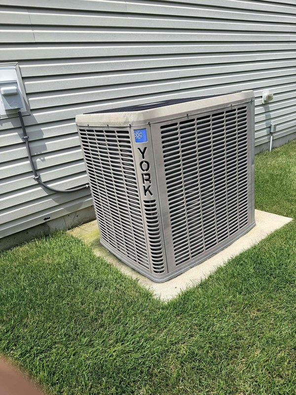 Conducted on-site evaluation of existing 10-year-old HVAC system for replacement estimate. Customer requested heat pump system with furnace backup configuration. Assessed current York air handler installed in crawlspace and exterior York condenser unit on concrete pad, documented existing ductwork, electrical connections, and plumbing infrastructure to determine replacement specifications and requirements.