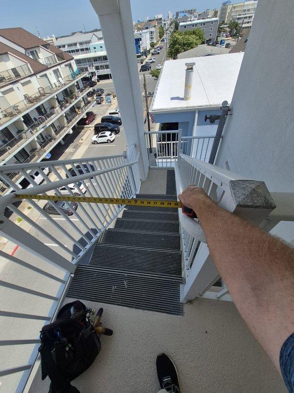 Responded to no cooling call on residential HVAC system with 5-degree temperature differential between setpoint and actual room temperature. Upon arrival, confirmed air handler was operating and delivering airflow but system was not producing cool air. Performed diagnostic inspection of rooftop condenser unit located on exterior balcony platform. Measured refrigerant line diameter and assessed overall system condition. Unit showed signs of age-related wear with weathered components and accumulated debris on surfaces. Documentation photos captured for service records and proposal revision purposes.