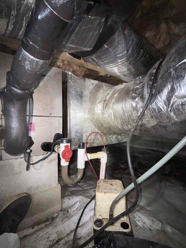 Responded to no-cooling call on downstairs system where outdoor unit was running but no airflow was present. Upon inspection in crawlspace, found air handler with wiring exposed during troubleshooting and confirmed lack of blower operation. Instructed customer to shut system off and set thermostat fan to "on" position to verify blower motor functionality independently of cooling cycle, isolating the issue to indoor air handler components rather than outdoor condensing unit.