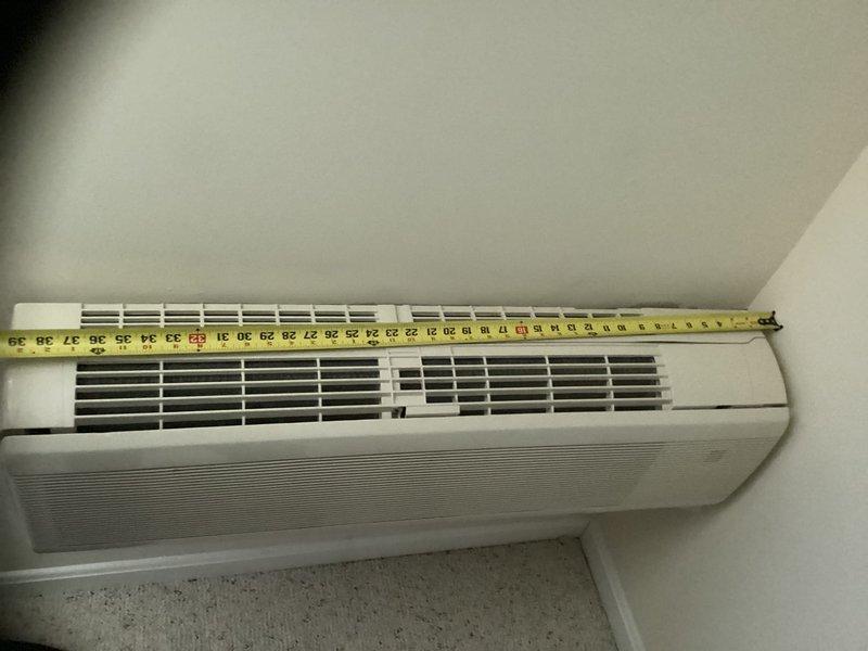 Conducted on-site evaluation of existing 15,000 BTU ductless mini-split system servicing above-garage room. Unit is approximately 18 years old, wall-mounted near ceiling in corner location, currently operational but replacement requested due to age. Measured existing indoor air handler dimensions and documented installation configuration. Assessed room layout, electrical access, and refrigerant line routing for replacement equipment specifications. Provided estimate for complete mini-split system replacement including new indoor and outdoor units.
