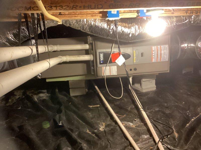 Conducted estimate for complete HVAC system replacement in crawl space. Assessed existing York heating and cooling unit, including horizontal furnace installation with current ductwork and PVC venting configuration. Documented equipment condition, spatial constraints, and provided recommendations for new system installation to replace aging unit.