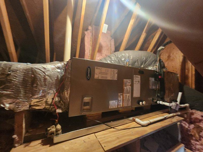 Completed full HVAC system replacement including removal and disposal of existing equipment. Installed Carrier 27SCA530A003 2.5-ton 15 SEER heat pump with outdoor unit mounted on pressure-treated wood platform, Carrier FJ5ANXB30L00 air handler positioned in attic space on reinforced wooden platform, and Carrier FC-2601C10 10kW electric heat pack. Fabricated and installed metal duct transitions to adapt new equipment to existing ductwork. Replaced outdoor disconnect and electrical whip while reusing existing electrical service, condensate drain lines, and refrigerant line set. Installed Honeywell TH6320WF digital WiFi thermostat for system control. All equipment installed per manufacturer specifications with proper electrical connections, condensate drainage, and ductwork sealed. System tested and operational upon completion.