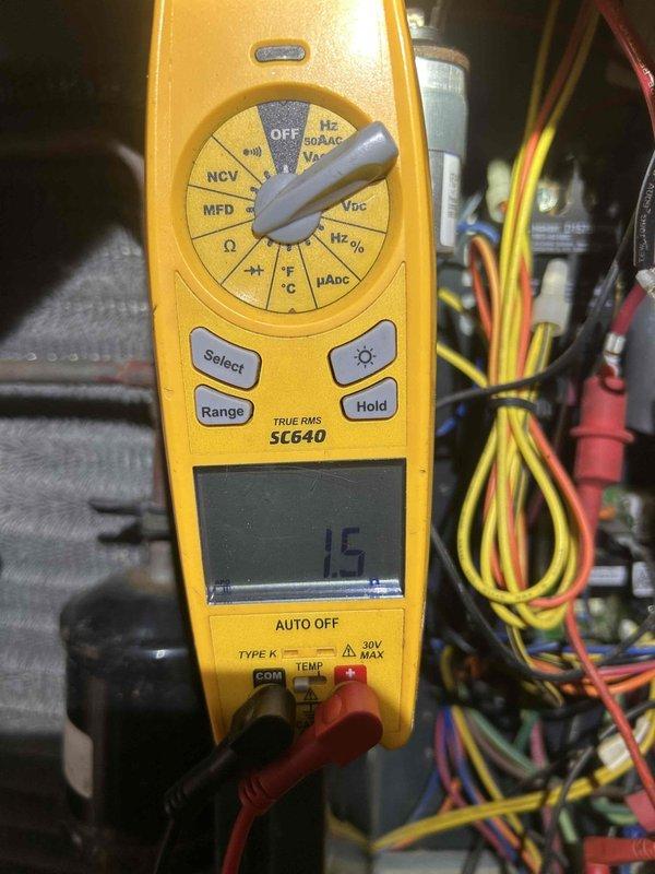 Responded to no cooling call affecting entire main floor. Upon arrival, found air conditioning system completely non-operational. Performed diagnostic testing using digital multimeter to measure capacitor values on outdoor condensing unit. Readings indicated dual run capacitor had failed, measuring 10 microfarads on one terminal and 15 microfarads on the other, both below manufacturer specifications. Replaced defective capacitor with proper OEM replacement, restored power to unit, and verified system operation with all electrical components functioning within normal parameters. System now cooling properly throughout affected areas.