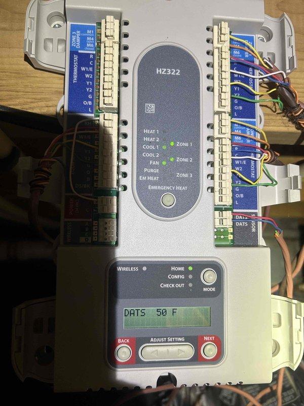 Responded to service call for loud "jet engine" noise originating from crawlspace HVAC unit on 8-year-old system. Upon arrival, noise had ceased when thermostats were adjusted upward. Inspected zone control panel (HZ322) and verified proper operation of all three zones with correct wiring connections and terminal integrity. Accessed crawlspace unit and observed significant condensation accumulation on ductwork and metal surfaces, indicating high humidity conditions and possible airflow restriction. Deployed diagnostic equipment to assess system performance and airflow parameters. System currently operational for both heating and cooling modes with no active fault codes present. Advised customer that intermittent noise may be related to recent baffle modifications affecting airflow dynamics or blower motor operation under high-demand conditions, and recommended monitoring system performance as outdoor temperatures increase.