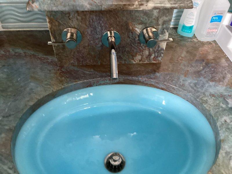 Responded to service call for difficult-to-operate cold water faucet handle in master bathroom. Upon inspection, found wall-mounted three-piece faucet assembly with separate hot and cold control valves and center spout. Diagnosed stiff cold water valve operation likely caused by mineral buildup or worn internal cartridge components. Disassembled cold water control valve, inspected cartridge mechanism, cleaned mineral deposits, and lubricated moving parts. Tested valve operation to ensure smooth handle rotation and proper water flow control. Verified no leaks at valve body or wall connections. Faucet now operates smoothly with full range of motion restored to cold water handle.