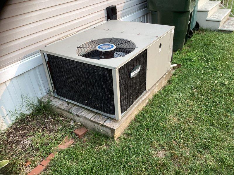 Conducted on-site evaluation of existing residential HVAC system for complete replacement estimate. Assessed outdoor condenser unit with beige metal cabinet housing and aging concrete pad, noting typical weathering consistent with system age. Documented current Honeywell digital thermostat displaying 72 degrees with auto fan operation. Provided comprehensive replacement options and recommendations for new system installation.
