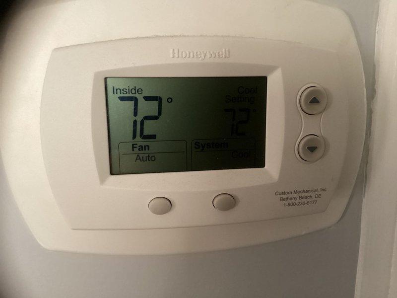 Conducted on-site evaluation of existing residential HVAC system for complete replacement estimate. Assessed outdoor condenser unit with beige metal cabinet housing and aging concrete pad, noting typical weathering consistent with system age. Documented current Honeywell digital thermostat displaying 72 degrees with auto fan operation. Provided comprehensive replacement options and recommendations for new system installation.