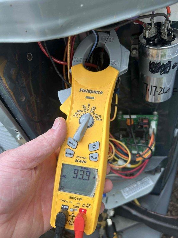 # HVAC Service Call - No Cooling Condition

Responded to a no cooling complaint on a 6-8 year old residential air conditioning system that was completely non-operational. Upon arrival, confirmed unit was powered off and not responding.

Performed diagnostic evaluation of the outdoor condensing unit. Removed access panel to inspect electrical components and control circuit. Using Fieldpiece SC440 clamp meter, tested electrical values at the compressor capacitor (NW50440 model, date code 1720). Measured current draw and voltage readings to determine component functionality.

Inspection revealed failed run capacitor preventing compressor operation. Capacitor showed no measurable capacitance and exhibited visible deterioration. Additionally, identified defective compressor relay (Supco brand) that was not engaging properly, contributing to the no-start condition.

Replaced failed dual run capacitor with appropriate microfarad-rated replacement matching manufacturer specifications. Installe