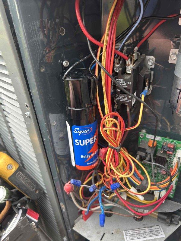 # HVAC Service Call - No Cooling Condition

Responded to a no cooling complaint on a 6-8 year old residential air conditioning system that was completely non-operational. Upon arrival, confirmed unit was powered off and not responding.

Performed diagnostic evaluation of the outdoor condensing unit. Removed access panel to inspect electrical components and control circuit. Using Fieldpiece SC440 clamp meter, tested electrical values at the compressor capacitor (NW50440 model, date code 1720). Measured current draw and voltage readings to determine component functionality.

Inspection revealed failed run capacitor preventing compressor operation. Capacitor showed no measurable capacitance and exhibited visible deterioration. Additionally, identified defective compressor relay (Supco brand) that was not engaging properly, contributing to the no-start condition.

Replaced failed dual run capacitor with appropriate microfarad-rated replacement matching manufacturer specifications. Installe