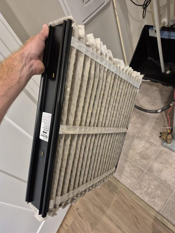 Responded to report of water leak through ceiling originating from air handler unit Q150+BT. Upon inspection, found evidence of condensate drainage issue at the air handler. Inspected and photographed the air filter, which showed typical dust accumulation and required replacement. Examined refrigeration line connections and service valves on outdoor unit, noting weathered copper piping with surface oxidation and corrosion on lower valve assembly. Addressed leak source and documented equipment condition for service records.