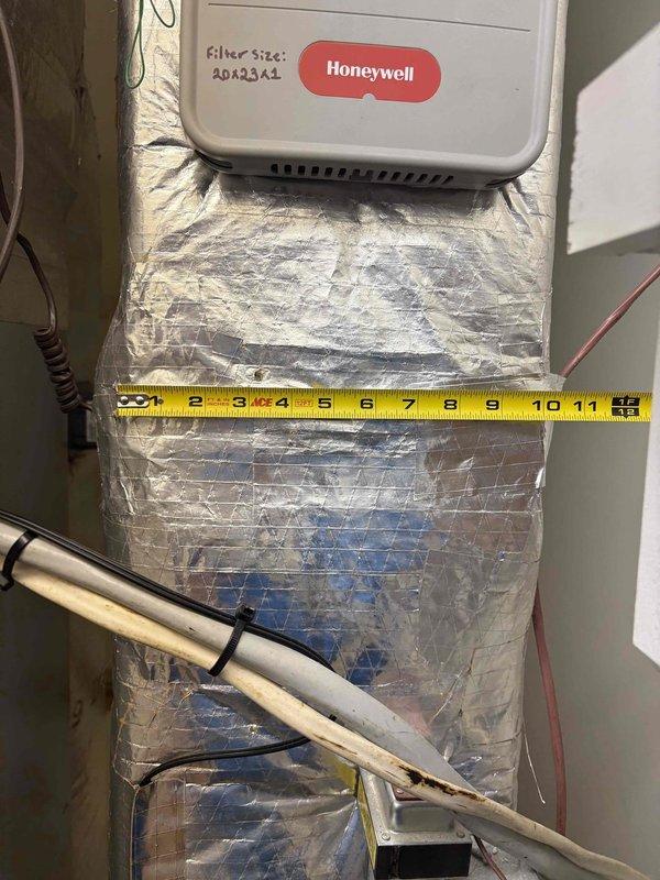 Responded to no cooling complaint on lower level of dual-zone system. Found evaporator coil frozen due to continuous fan operation and reduced airflow. Measured supply duct dimensions and verified refrigerant lines. Instructed customer to turn system off to allow coil to thaw, switch thermostat fan from "on" to "auto" position, and verified upper zone operating normally at setpoint.