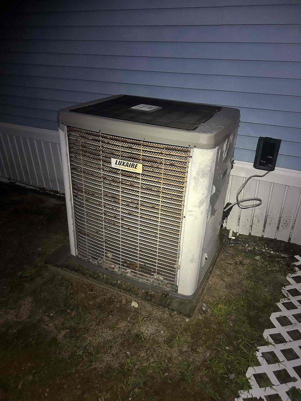 # HVAC Service Report

Responded to no cooling complaint on Luxaire split system. Upon arrival, found system not operating. Connected manifold gauges to service ports on indoor unit refrigerant lines. Performed diagnostic testing and system evaluation. Refrigerant lines showed evidence of recent service work with red caps on connection points. Inspected outdoor condenser unit and found equipment in weathered but operational condition. Electrical disconnect and wiring connections verified at outdoor unit location. System assessed and service procedures completed to restore cooling operation.