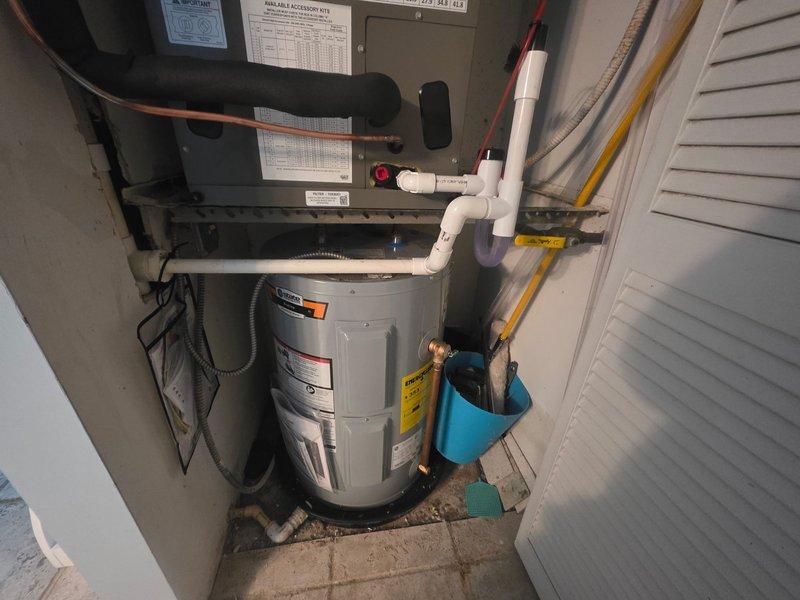 Completed full HVAC system replacement including removal and disposal of existing equipment. Installed National Comfort Product NCP5241000A-A1 2-ton side discharge air conditioning unit in condenser closet, Lennox CBK43UHET-024 air handler with Lennox 10KW electric heat kit, and Honeywell TH6320WF digital WiFi thermostat. Fabricated and installed metal duct transitions to adapt new equipment to existing ductwork. Reused existing condensate drain lines and power lines where feasible. Replaced outdoor electrical disconnect and whip for code compliance. All equipment installed per manufacturer specifications with one-year parts warranty from installation date. System tested and operational upon completion.