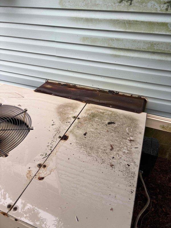 # HVAC Service Call - No Cooling

Responded to service call for residential air conditioning system not operating. Upon arrival, found outdoor condenser unit with significant dirt and debris accumulation on top panel, along with visible algae and mildew growth indicating lack of regular maintenance. Inspected electrical panel and verified power supply to HVAC system at main breaker and dedicated circuit breaker. Unit showed signs of extended outdoor exposure with weathered components and surface contamination affecting overall condition. Documented equipment condition with photographs for service records. Customer notified of system status and maintenance requirements.
