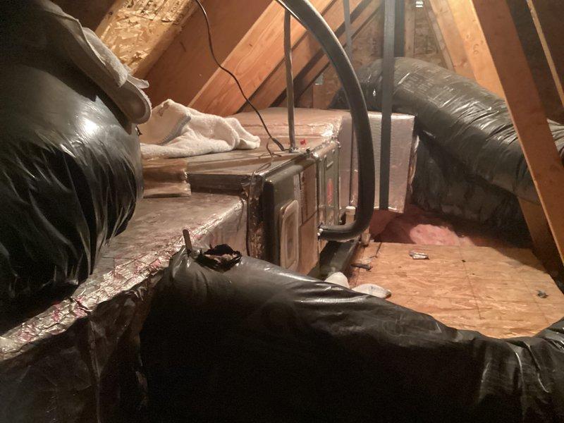 Conducted HVAC system evaluation for complete replacement of existing heating and cooling equipment. Assessed attic-mounted air handler and ductwork system, documenting current configuration including flexible duct routing through attic space and mechanical connections. Inspected ceiling access panel for equipment accessibility. Provided comprehensive replacement estimate covering both upstairs and downstairs HVAC units, and discussed available Energize Delaware energy efficiency program options with customer.