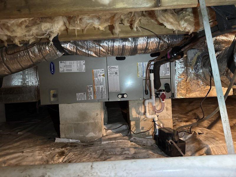 Completed full system replacement including removal and disposal of existing HVAC equipment. Installed new Carrier 27SCA530A003 2.5-ton 15 SEER heat pump with outdoor unit mounted on pressure-treated wood platform, Carrier FJ5ANXB30L00 air handler in crawl space, and Carrier 10kw electric heat pack. Fabricated and installed metal duct transitions to adapt new equipment to existing ductwork. Replaced outdoor disconnect and electrical whip while reusing existing electrical service, condensate drain lines, and power connections. Installed Honeywell TH6320WF digital WiFi thermostat for system control. Secured air handler on concrete block supports with proper clearances, verified all electrical connections meet code requirements, tested condensate drainage system, and confirmed proper airflow through adapted ductwork. System commissioned, tested for proper operation in heating and cooling modes, and filter installed at unit. Customer enrolled in one-year platinum comprehensive maintenance 