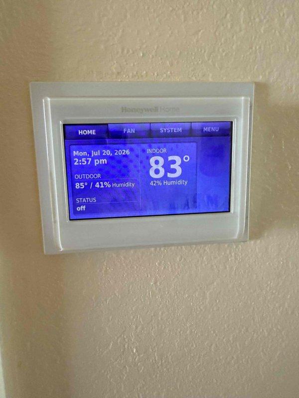Performed on-site evaluation for complete air conditioning system replacement at residential property experiencing total AC failure. Assessed existing electrical panel capacity and thermostat configuration, documented current Honeywell Home digital thermostat displaying 83° indoor temperature with system in off status, and verified electrical infrastructure to determine compatibility requirements for new HVAC equipment installation.
