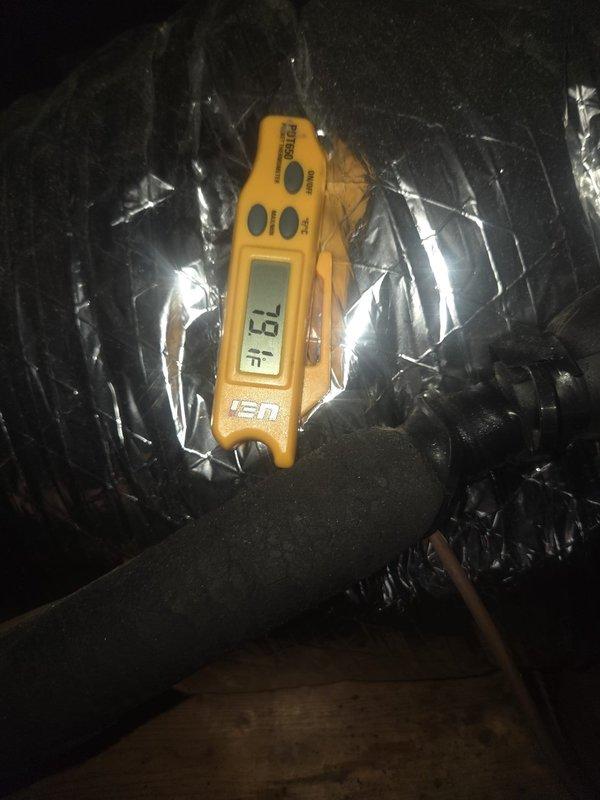 Responded to no cooling complaint on second floor system. Upon arrival, measured supply air temperature at ductwork in attic space, recording 52.1°F at supply plenum and 73°F return air temperature, indicating adequate temperature split and proper system operation. System achieving designed cooling capacity with appropriate airflow across evaporator coil.