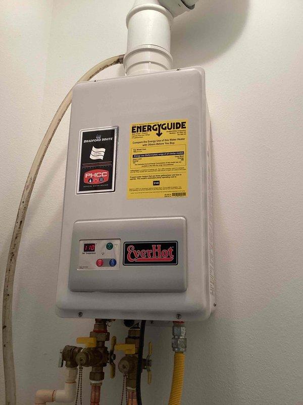 Responded to no hot water complaint at rental property. EverHot tankless water heater displayed error code 11 indicating ignition failure. Removed front cover and performed diagnostic inspection of internal components. Inspected heat exchanger, copper piping, control boards, electrical connections, and gas supply line. Identified ignition system malfunction preventing unit from firing. Cleared error code, tested gas flow through yellow flexible gas line, verified proper venting through PVC exhaust pipe, and checked all water inlet/outlet connections with brass shut-off valves. Restored unit to proper operation and confirmed hot water delivery. System tested and operational upon departure.