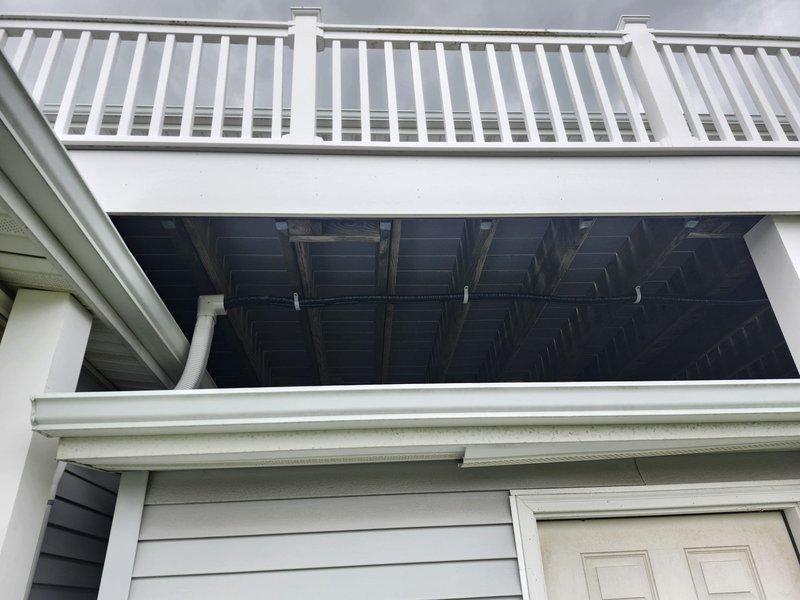 Completed installation of Mitsubishi ductless mini-split heat pump system consisting of one MITMUZ-GX12NL 12,000 BTU 25 SEER outdoor unit and one MITMSZGX12NL 12,000 BTU wall-mounted indoor air handler with remote thermostat. Routed refrigerant lines through wall and crawlspace to outdoor unit location. Mounted outdoor condenser on wooden platform adjacent to existing HVAC units. Coordinated with licensed electrician on-site to install dedicated electrical circuit and disconnect box for system power supply. System tested and operational upon completion with one-year ductless service contract included.