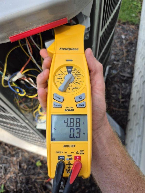 Completed preventive maintenance cooling visit on two HVAC systems. Performed diagnostic testing using digital meters to verify system performance, recording temperature readings of 38.5°F at evaporator coil and electrical measurements showing 4.88 amps current draw with 0.3 volts. Inspected condenser unit components, noted accumulation of dirt and dust on heat exchanger coils and filter housing requiring attention during future service intervals.