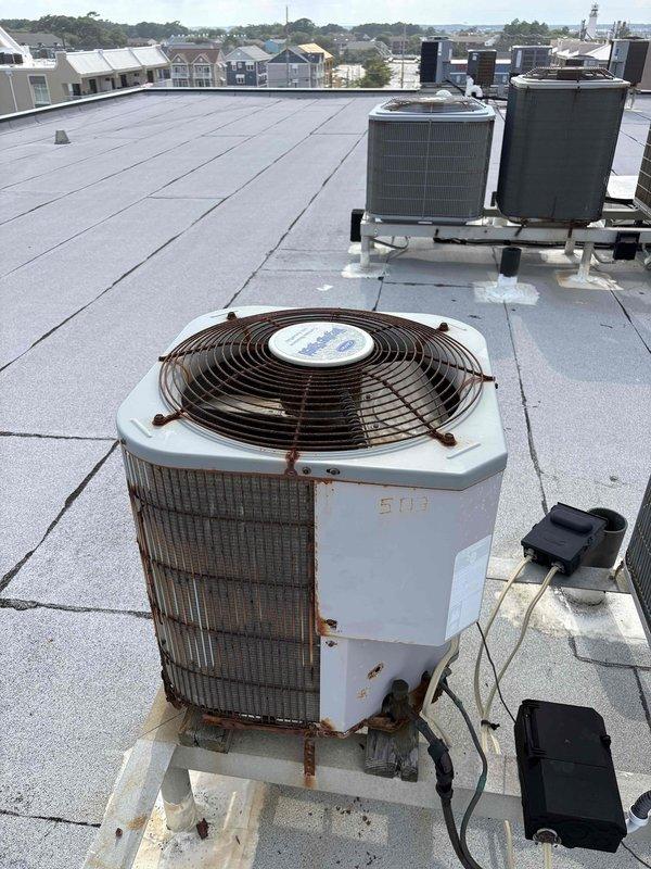 Responded to no cooling complaint on rooftop HVAC unit. Upon inspection, found heavily corroded condenser unit with significant rust deterioration on cabinet surfaces, edges, and components. Unit showed advanced weathering and age-related degradation affecting exterior metal surfaces. Accessed interior space via ladder to assess airflow and verify system operation. Documented equipment condition with photographs showing extensive corrosion patterns and compromised structural integrity of outdoor unit housing. Provided estimate for necessary repairs or replacement recommendations based on severity of rust damage and unit condition.
