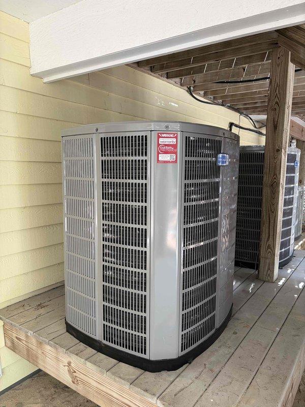 Completed full heat pump system installation by removing and disposing of old equipment, then installing one American Standard 5A6H4060A1000 4.5-ton 14 SEER single-stage heat pump with matching American Standard 5TXCD010AS3HC evaporator coil. Fabricated and installed metal duct transitions to adapt new equipment to existing ductwork, reused existing furnace and thermostat, replaced outdoor disconnect and electrical whip, reconnected existing condensation drain and power lines, and positioned outdoor unit on existing equipment stand under covered porch area.