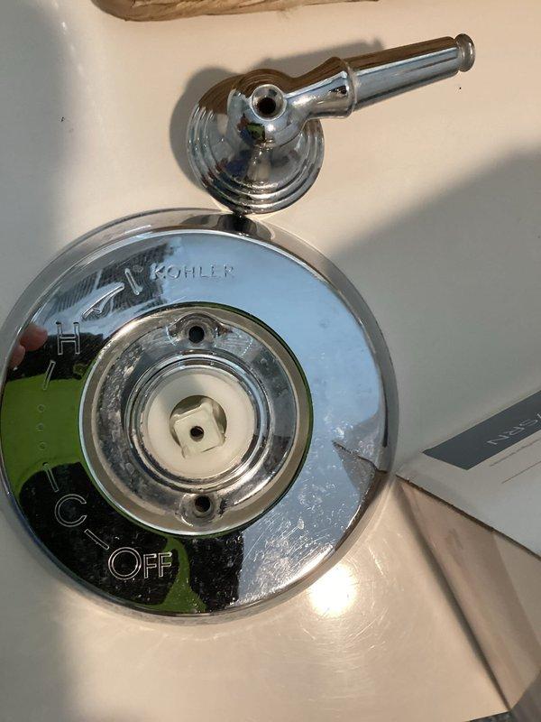 Completed on-site assessment of bathroom shower valve requiring replacement. Inspected existing Kohler brand shower control fixture with chrome trim plate showing signs of age, mineral deposits, and wear around the central control mechanism. Documented current valve condition and bathroom layout to provide accurate estimate for shower valve replacement, including access considerations and fixture specifications needed for the repair.