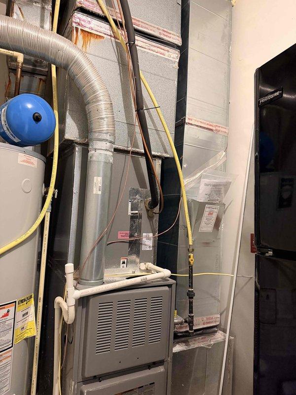 Responded to service call for HVAC unit with reported system leak located on second floor. Upon inspection of mechanical room, evaluated existing furnace, ductwork, water heater, and associated gas lines and copper piping. Documented current equipment configuration including metallic ductwork, insulated copper lines, and electrical components. Provided comprehensive estimate for complete system replacement to address leak and ensure proper operation of heating equipment.