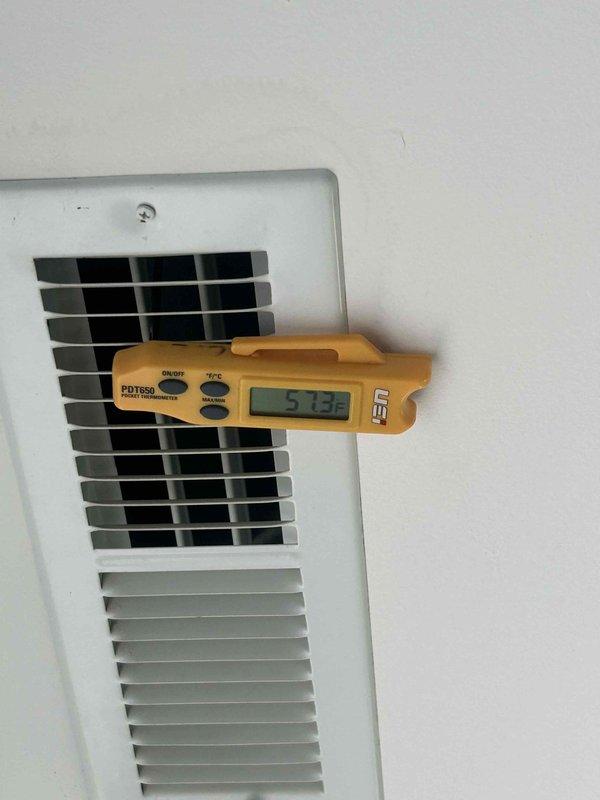 Responded to no-cool call for upstairs unit not reaching setpoint with condensate drainage issue. Upon arrival, measured supply air temperature at 57.3°F and return air temperature at 79.5°F, confirming adequate temperature split and proper refrigerant charge. Identified primary issue as clogged condensate drain line preventing proper drainage. Cleared condensate line obstruction, verified proper drainage flow, and confirmed system cooling operation. Unit restored to normal operation with proper airflow and condensate removal.