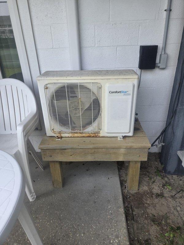 Completed preventative maintenance cooling inspection on two residential air conditioning systems. Performed comprehensive Cool Check service on both outdoor condenser units, including one cylindrical unit mounted on weathered wooden platform in backyard and one ComfortStart Platinum unit positioned on elevated wooden stand against exterior wall. Inspected electrical disconnects, refrigerant lines, condensate drainage, and verified proper operation of both cooling systems.