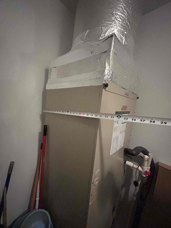# HVAC Maintenance - Cooling System Service

Performed routine cooling maintenance visit on residential air handling unit. Upon inspection, discovered evaporator coils heavily soiled with significant dust, dirt, and debris accumulation throughout the fin surfaces, particularly in lower sections where buildup was most severe. The clogged condition was restricting airflow and reducing system efficiency.

Accessed air handler unit and replaced air filter as part of standard maintenance protocol. Documented existing coil condition with photographs showing extent of contamination on heat exchanger fins and internal components. The metallic fins displayed uneven deposits with darker, thicker accumulation in concentrated areas, indicating extended operation without recent cleaning.

Inspected ductwork connections and cabinet housing, noting normal wear consistent with system age. All accessible components were visually examined for proper operation. System measurements were taken and recorded