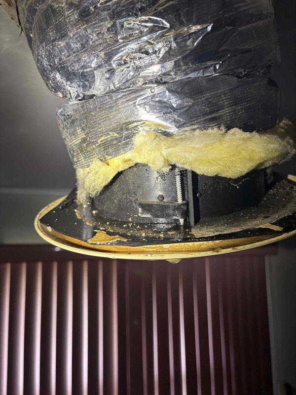 Responded to report of water leak originating from attic space and penetrating through ceiling. Upon inspection, confirmed leak source was HVAC unit rather than roofing system. Examined flexible ductwork installation in attic, noting deteriorated insulation wrap and compromised duct connections. Documented condition of metallic flex duct showing wear patterns and areas where reflective coating had degraded. Observed fiberglass insulation displacement around ductwork with visible moisture exposure and debris accumulation on surrounding surfaces. Inspected duct collar connections and identified potential condensation issues contributing to water intrusion through ceiling below.