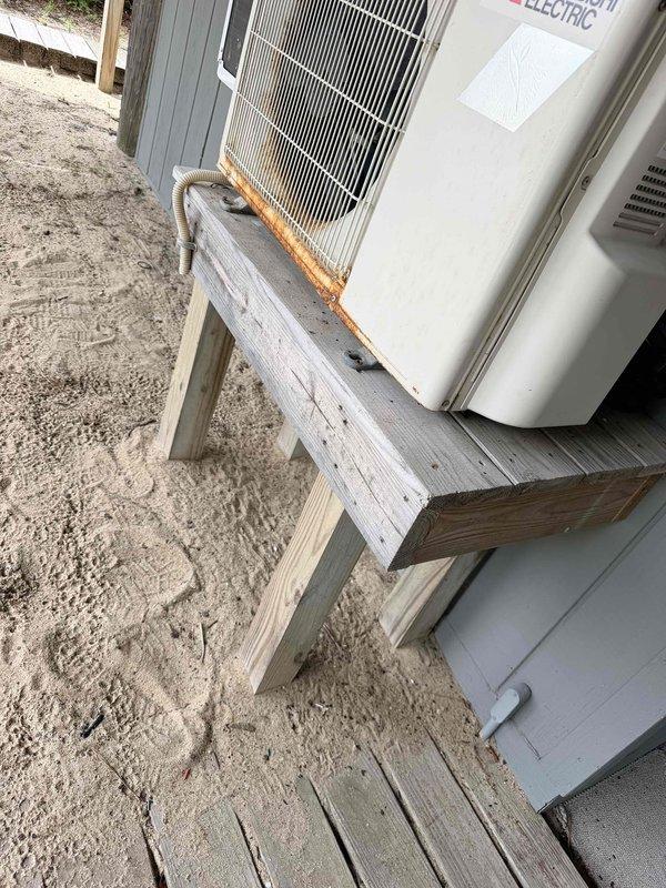 Completed diagnostic evaluation on a 2020 Mitsubishi MUZ-FH09NA mini-split outdoor unit experiencing operational failure due to faulty PCB board. Determined replacement of control board and installation of surge protector required to restore system functionality. Documented exterior unit condition including rust staining on condensing unit casing and refrigerant lines, and noted potential future relocation of outdoor unit per owner preference. Parts ordered with estimated two-week lead time for repair completion.