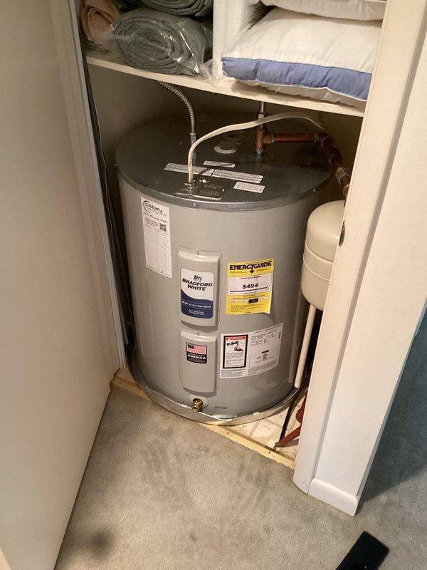 Removed and replaced existing water heater with Bradford White 50-gallon lowboy unit (model RE250L61). Installation included 28-inch drain pan, expansion tank, two 18-inch flexible water connectors, brass fittings (3/4" x 4" nipple, 3/4" x 6" nipple, 3/4" 90-degree elbow, 3/4" tee), and high-temperature male adapters. All plumbing connections secured with proper fittings and tested for leaks. Unit installed in utility closet space on platform base with adequate clearance. Verified proper venting, temperature/pressure relief valve operation, and all safety controls functioning correctly.

Additionally installed two replacement toilets and disposed of old units per customer request.