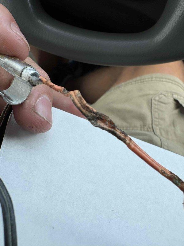 Responded to no cooling complaint on 10+ year old system where unit was not maintaining temperature and reached 82 degrees overnight. Upon inspection, discovered severe corrosion and deterioration on copper refrigerant lines and extensive rust damage throughout outdoor unit components, including corroded pipe connections and mechanical housing. System exhibited significant moisture damage and oxidation consistent with age and environmental exposure, compromising refrigerant circuit integrity and preventing proper cooling operation.