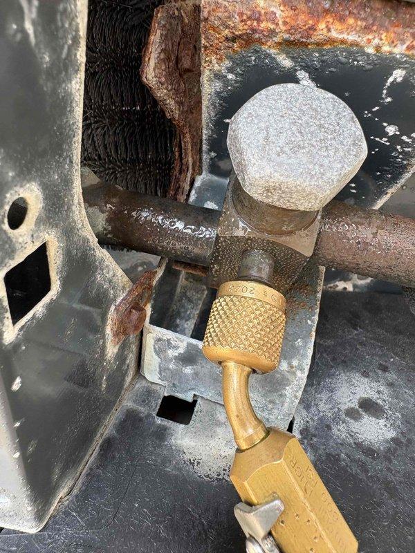 Responded to no cooling complaint on 10+ year old system where unit was not maintaining temperature and reached 82 degrees overnight. Upon inspection, discovered severe corrosion and deterioration on copper refrigerant lines and extensive rust damage throughout outdoor unit components, including corroded pipe connections and mechanical housing. System exhibited significant moisture damage and oxidation consistent with age and environmental exposure, compromising refrigerant circuit integrity and preventing proper cooling operation.