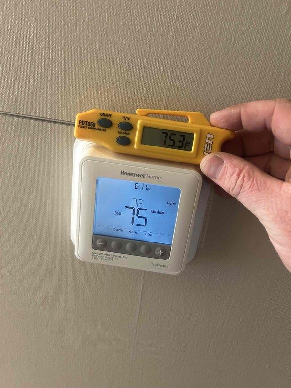 Responded to no cooling call and performed system diagnostics. Measured supply air temperature at return vent registering 75.3°F and confirmed thermostat was calling for cooling with setpoint at 75°F. Verified system operation and determined air conditioning unit was functioning properly with adequate airflow through ventilation system.