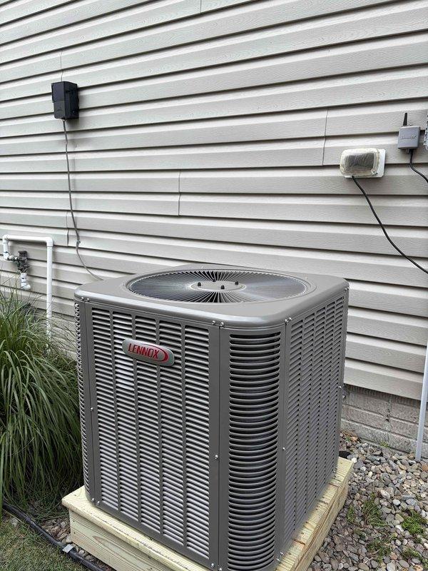 Completed full HVAC system replacement including removal and disposal of existing outdoor air conditioning unit and indoor evaporator coil. Installed new Lennox ML14KC1-030 2.5 ton air conditioning condenser on concrete pad with proper leveling and positioning against exterior wall. Installed new CH33-HT36C evaporator coil to work with existing furnace system. Flushed and pressure tested all refrigerant lines to ensure system integrity, then recharged system to manufacturer specifications. Installed electrical whip and disconnect box on exterior siding with proper conduit routing and connections. Utilized existing thermostat for system control. Verified all electrical connections, tested system operation through complete cooling cycle, and confirmed proper airflow and temperature differential. Unit operational and performing to specifications upon completion.