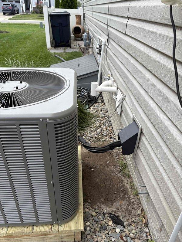 Completed full HVAC system replacement including removal and disposal of existing outdoor air conditioning unit and indoor evaporator coil. Installed new Lennox ML14KC1-030 2.5 ton air conditioning condenser on concrete pad with proper leveling and positioning against exterior wall. Installed new CH33-HT36C evaporator coil to work with existing furnace system. Flushed and pressure tested all refrigerant lines to ensure system integrity, then recharged system to manufacturer specifications. Installed electrical whip and disconnect box on exterior siding with proper conduit routing and connections. Utilized existing thermostat for system control. Verified all electrical connections, tested system operation through complete cooling cycle, and confirmed proper airflow and temperature differential. Unit operational and performing to specifications upon completion.