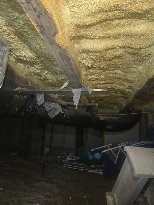 Responded to no cooling complaint on heat pump system over 10 years old. Upon arrival, accessed unit and performed system diagnostics. Customer reported excessive airflow to powder room, suspecting ductwork imbalance. Inspected crawl space ductwork and found flexible duct runs with potential airflow distribution issues. Documented system conditions with photos showing spray foam insulated ceiling areas, flexible aluminum ductwork, and overall crawl space infrastructure. Assessed duct routing, support strapping, and insulation integrity throughout accessible areas. Identified ductwork configuration contributing to uneven air distribution between zones. Provided recommendations for ductwork modifications to balance airflow and address comfort concerns in affected room.