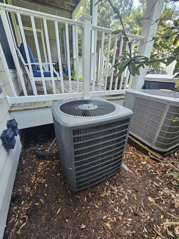 Completed comprehensive tune-up inspection on residential cooling system with dual outdoor condenser units located near elevated deck area. Verified thermostat operation showing system actively cooling with 75°F ambient temperature and 68°F setpoint, confirmed proper communication between Honeywell digital control and equipment. Inspected outdoor units positioned on mulched ground, assessed overall system condition, and advised customer of findings with repair recommendations exceeding standard maintenance scope.