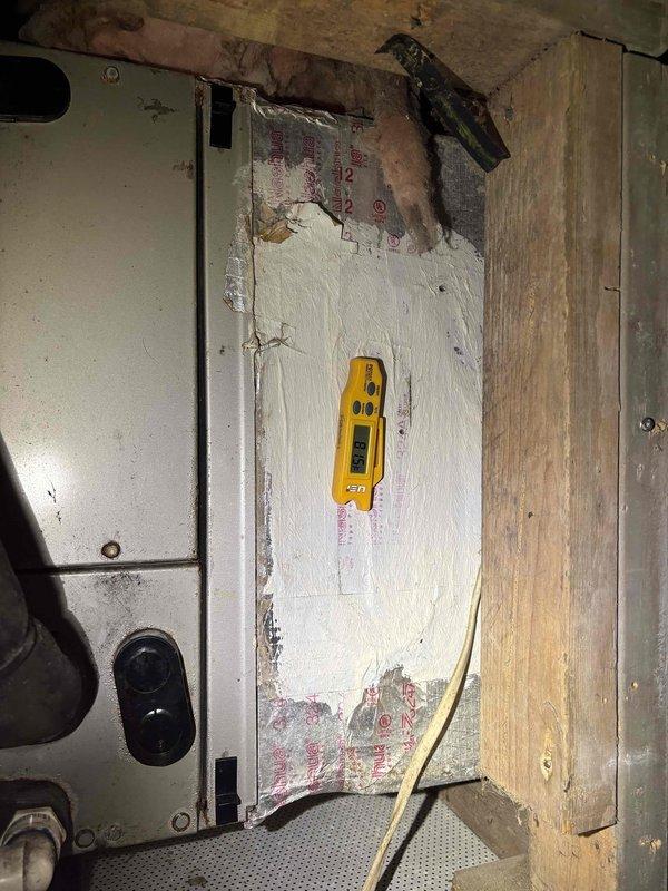 Responded to emergency no-cool call and accessed system in confined attic space to diagnose air conditioning failure. Upon inspection with diagnostic equipment, identified critical component failure preventing system operation, documented conditions with photos showing HVAC equipment and electrical connections in maintenance area, and provided customer with repair options to restore cooling functionality.