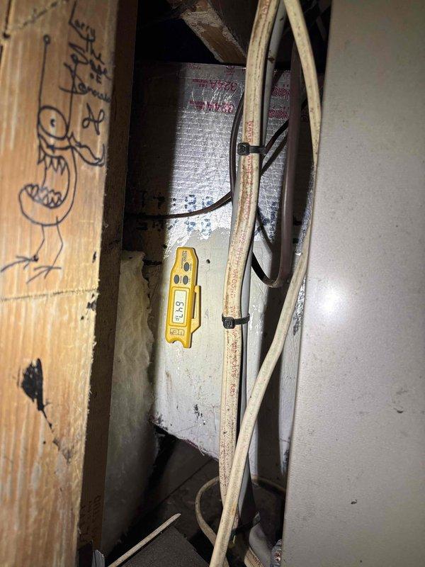 Responded to emergency no-cool call and accessed system in confined attic space to diagnose air conditioning failure. Upon inspection with diagnostic equipment, identified critical component failure preventing system operation, documented conditions with photos showing HVAC equipment and electrical connections in maintenance area, and provided customer with repair options to restore cooling functionality.