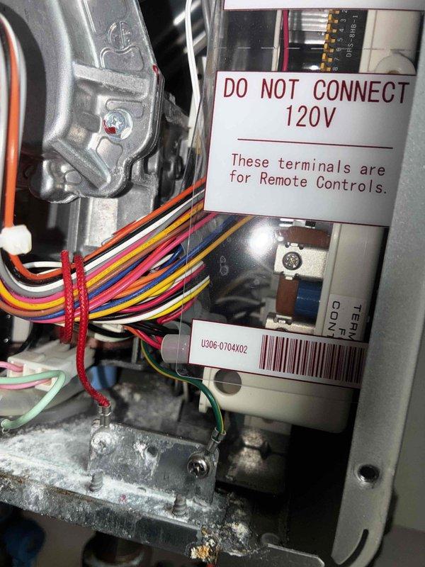 Responded to no-heat call for tankless water heater system. Upon inspection, found unit experiencing operational failure with control board and internal component issues. Accessed interior control panel and electrical connections, identifying worn wiring harnesses and deteriorated terminal connections. Documented internal condition showing significant dust and debris accumulation affecting system performance. Inspected heat exchanger panels displaying heat stress discoloration and age-related wear. Evaluated gas valve assembly, copper piping connections, and electrical wiring integrity throughout unit. Photographed control board assembly, safety warning labels, and internal components for service documentation and future reference.