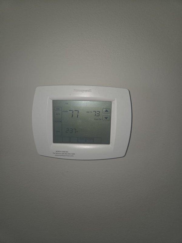 Responded to no cooling complaint on residential HVAC system. Upon arrival, confirmed unit was not providing adequate cooling with thermostat displaying 77°F actual temperature while set to 73°F in cooling mode. Performed diagnostic evaluation of the system and added UV dye to refrigerant circuit to identify potential leak locations for future monitoring and repair assessment.