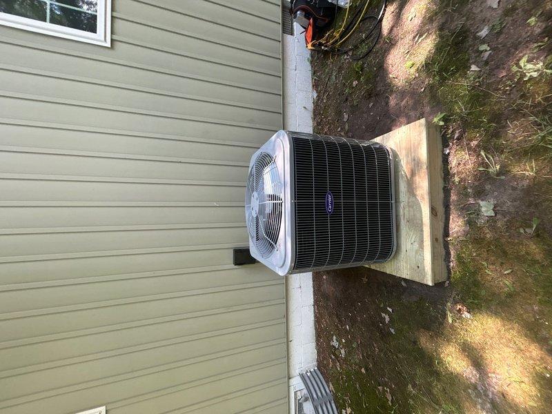 Completed full HVAC system replacement including removal and disposal of existing equipment. Installed new Carrier 27SCA536A003 3-ton 15 SEER heat pump outdoor unit on existing stand, Carrier FJ5ANXB36L00 air handling unit with ECM motor, and 10kw electric heat pack. Fabricated and installed metal duct transitions to adapt new equipment to existing ductwork. Replaced outdoor electrical disconnect and whip while reusing existing condensation drain and power lines. Installed Honeywell digital WiFi thermostat with filter at unit. System tested and operational with one-year PLAT extension activated from expiration date.