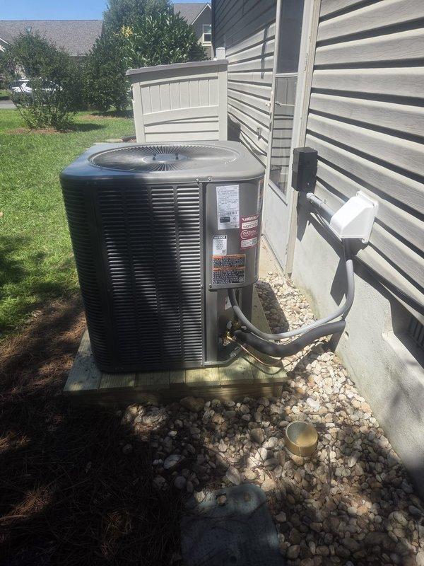 Completed full HVAC system replacement including removal and disposal of existing equipment. Installed ML14KP1-030 2.5 ton 15.5 SEER heat pump outdoor unit on platform with proper gravel drainage, CBK45UHVT-030 variable speed air handler, ECB45-10CB 10KW electric heater with breaker, and THX1200W WiFi thermostat. Flushed, pressure tested, and recharged refrigeration lines, installed electrical whip and disconnect box, and secured all copper line sets to exterior siding with proper mounting brackets. System tested and operational.