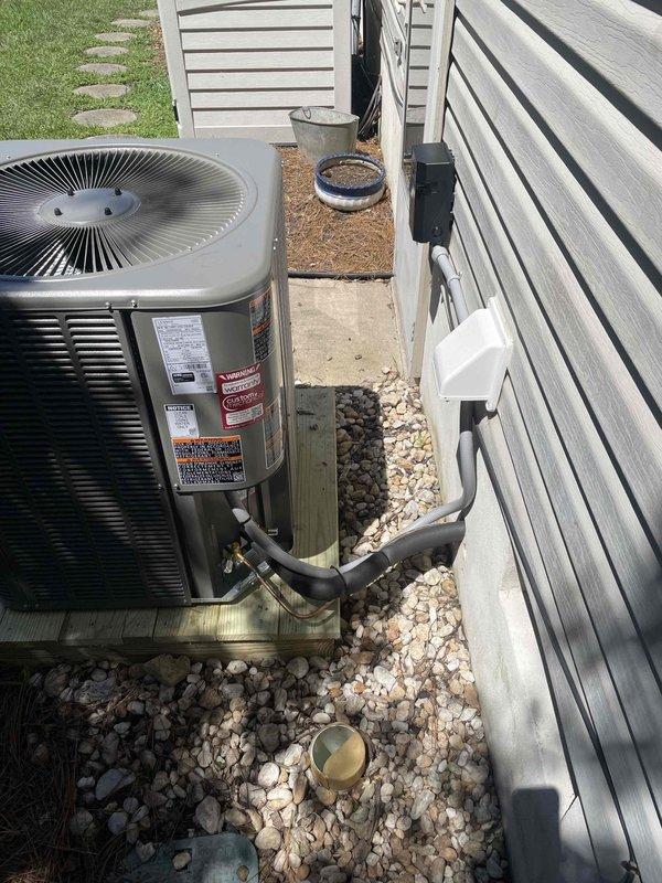 Completed full HVAC system replacement including removal and disposal of existing equipment. Installed ML14KP1-030 2.5 ton 15.5 SEER heat pump outdoor unit on platform with proper gravel drainage, CBK45UHVT-030 variable speed air handler, ECB45-10CB 10KW electric heater with breaker, and THX1200W WiFi thermostat. Flushed, pressure tested, and recharged refrigeration lines, installed electrical whip and disconnect box, and secured all copper line sets to exterior siding with proper mounting brackets. System tested and operational.