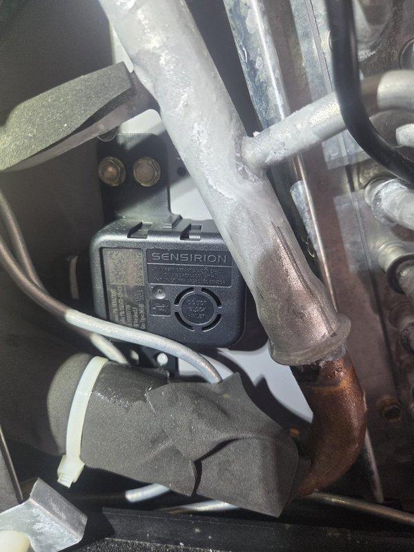 # HVAC Service Report

Responded to no cooling complaint for downstairs zone. Upon inspection, accessed control board and sensor assembly within air handling system. Evaluated circuit board connections, relay operations, and sensor functionality. Inspected Sensirion sensor mounted on refrigerant lines, noting age-related corrosion on copper piping but sensor appeared operational. Verified all wire connections at control board terminals and multi-pin connectors were secure. Checked system components for proper communication and operation to restore cooling to affected zone.